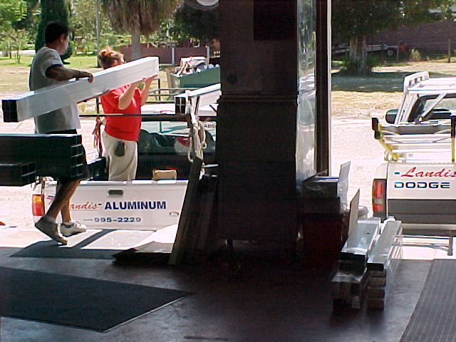 Landis Aluminum crew loading aluminum extrusions onto a company pickup truck at the shop